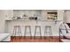 Kitchen bar area with seating and stainless steel appliances in an open floor plan at 13577 W Alaska Dr, Lakewood, CO 80228