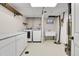 Laundry room featuring white cabinets, a washer and dryer set, and laundry sink at 13577 W Alaska Dr, Lakewood, CO 80228