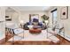 Comfortable living room featuring stylish seating, a round coffee table, and natural light from the window at 13577 W Alaska Dr, Lakewood, CO 80228