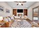 Comfortable living room featuring built-in shelving, fireplace, and stylish modern décor at 13577 W Alaska Dr, Lakewood, CO 80228