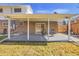 This covered patio features concrete flooring, and an open view of the yard at 13577 W Alaska Dr, Lakewood, CO 80228