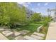 Backyard area with green grass, stone walking path and modern building in the background at 2550 Lawrence St # Rb306, Denver, CO 80205