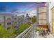 Balcony view overlooking community lawn, modern condo buildings, and the city skyline at sunset at 2550 Lawrence St # Rb306, Denver, CO 80205