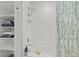 Bright bathroom with white subway tile shower, open shelving, and stylish bamboo-patterned shower curtain at 2550 Lawrence St # Rb306, Denver, CO 80205