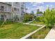 Green lawn in community setting with condo building and unique swing set at 2550 Lawrence St # Rb306, Denver, CO 80205