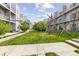Lush green lawn with swing sets between rows of apartment buildings offering a vibrant community setting at 2550 Lawrence St # Rb306, Denver, CO 80205