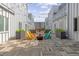 Modern courtyard with colorful Adirondack chairs surrounding a fire pit and overhead string lights at 2550 Lawrence St # Rb306, Denver, CO 80205