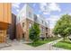 Modern multi-level condo building with brick facade, metal accents, and professional landscaping at 2550 Lawrence St # Rb306, Denver, CO 80205