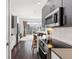 Modern kitchen features stainless steel appliances, white subway tile backsplash and hardwood floors at 2550 Lawrence St # Rb306, Denver, CO 80205
