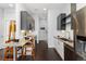 Modern kitchen features stainless steel appliances, sleek cabinetry, subway tile backsplash, and hardwood floors at 2550 Lawrence St # Rb306, Denver, CO 80205
