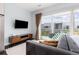 Main bedroom with hardwood floors, flat screen TV and large windows to patio at 2550 Lawrence St # Rb306, Denver, CO 80205