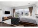 Spacious main bedroom with hardwood floors, couch and large window overlooking patio at 2550 Lawrence St # Rb306, Denver, CO 80205