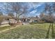 Large backyard with patio, mature trees, and a well-maintained lawn at 3597 S Joplin St, Aurora, CO 80013