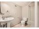 Standard bathroom with pedestal sink, toilet, and shower enclosure at 3597 S Joplin St, Aurora, CO 80013