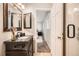 Bathroom featuring a dark wood vanity and an open doorway to a bedroom at 3597 S Joplin St, Aurora, CO 80013
