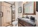 Bathroom featuring a glass enclosed shower and a dark wood vanity at 3597 S Joplin St, Aurora, CO 80013