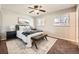 Comfortable bedroom with a ceiling fan, carpet, and two windows for natural light at 3597 S Joplin St, Aurora, CO 80013