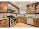 Cozy kitchen featuring stainless steel appliances, granite countertops, and wooden cabinetry at 3597 S Joplin St, Aurora, CO 80013