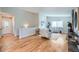 Bright living room with wood floors, light gray walls, modern furniture, and a cozy fireplace at 3597 S Joplin St, Aurora, CO 80013