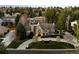 Breathtaking aerial view of a two-story home nestled amongst mature trees in a peaceful neighborhood at 6375 E Tufts Ave, Englewood, CO 80111