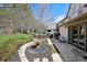 Landscaped backyard features a stone patio, water fountain, and ample seating for relaxation and entertainment at 6375 E Tufts Ave, Englewood, CO 80111