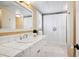 Bathroom with white tiled vanity, a shower with patterned curtain, and neutral wallpaper at 6375 E Tufts Ave, Englewood, CO 80111