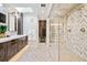 This updated bathroom features skylights, a dual shower, and a designer vanity at 6375 E Tufts Ave, Englewood, CO 80111