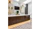 This updated bathroom features double sinks, custom cabinetry and vanity lighting at 6375 E Tufts Ave, Englewood, CO 80111