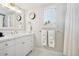 Bright, neutral bathroom featuring a white vanity, updated fixtures, and large mirror at 6375 E Tufts Ave, Englewood, CO 80111