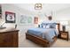 Comfortable bedroom with wood furnishings, a plush bed, and natural light at 6375 E Tufts Ave, Englewood, CO 80111