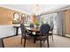Formal dining room featuring a round table, elegant chairs, and a bay window with custom drapes at 6375 E Tufts Ave, Englewood, CO 80111