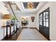 Inviting entryway featuring dark wood floors, a staircase, and an open view into the dining room at 6375 E Tufts Ave, Englewood, CO 80111