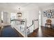 Sun-drenched hallway with hardwood floors and a custom runner leads into several rooms at 6375 E Tufts Ave, Englewood, CO 80111