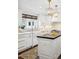Bright kitchen with a large farmhouse sink, stainless appliances, and butcher block island at 6375 E Tufts Ave, Englewood, CO 80111