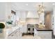 Well-lit kitchen with stainless steel appliances, custom cabinets, and marble countertops at 6375 E Tufts Ave, Englewood, CO 80111