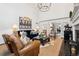 Elegant living room with a fireplace, comfortable seating, and an open floor plan to the dining area at 6375 E Tufts Ave, Englewood, CO 80111