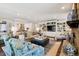 Spacious living room with built-in media center, fireplace, and view into the kitchen at 6375 E Tufts Ave, Englewood, CO 80111