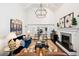 Elegant living room with fireplace, stylish furnishings, and access to the dining room at 6375 E Tufts Ave, Englewood, CO 80111