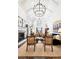 Bright living room featuring high vaulted ceilings, chandeliers, fireplace, and stylish decor at 6375 E Tufts Ave, Englewood, CO 80111