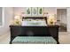 This bedroom suite features leafy artwork, neutral paint and carpet and ensuite bath at 6375 E Tufts Ave, Englewood, CO 80111