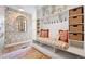 Inviting mudroom with patterned wallpaper, custom bench, and ample storage baskets at 6375 E Tufts Ave, Englewood, CO 80111