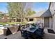 Outdoor patio features a dining table, outdoor kitchen, fire pit and lounge area for upscale entertainment at 6375 E Tufts Ave, Englewood, CO 80111