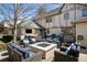Inviting patio area with a built-in fire pit, outdoor seating, and a barbecue for ultimate outdoor living at 6375 E Tufts Ave, Englewood, CO 80111