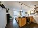 Open-concept kitchen with a breakfast bar and updated appliances, seamlessly flowing into the living area at 909 N Logan St # 3C, Denver, CO 80203