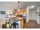 The condo's efficiently designed kitchen has bar seating, stainless appliances, and lots of natural light at 909 N Logan St # 3C, Denver, CO 80203