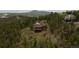 Stunning log home on a wooded lot, boasting scenic mountain views from its wrap around deck at 29095 Summit Ranch Dr, Golden, CO 80401