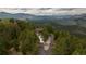 An aerial view of the property surrounded by dense trees and foliage at 29095 Summit Ranch Dr, Golden, CO 80401