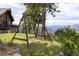 Lush backyard featuring a wooden swing set and stunning mountain views, perfect for outdoor fun at 29095 Summit Ranch Dr, Golden, CO 80401