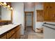 Bright bathroom with white countertop, wood cabinets and access to a closet and wood bench at 29095 Summit Ranch Dr, Golden, CO 80401