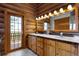 Bathroom with a double sink vanity, wood cabinets and a door to the balcony at 29095 Summit Ranch Dr, Golden, CO 80401